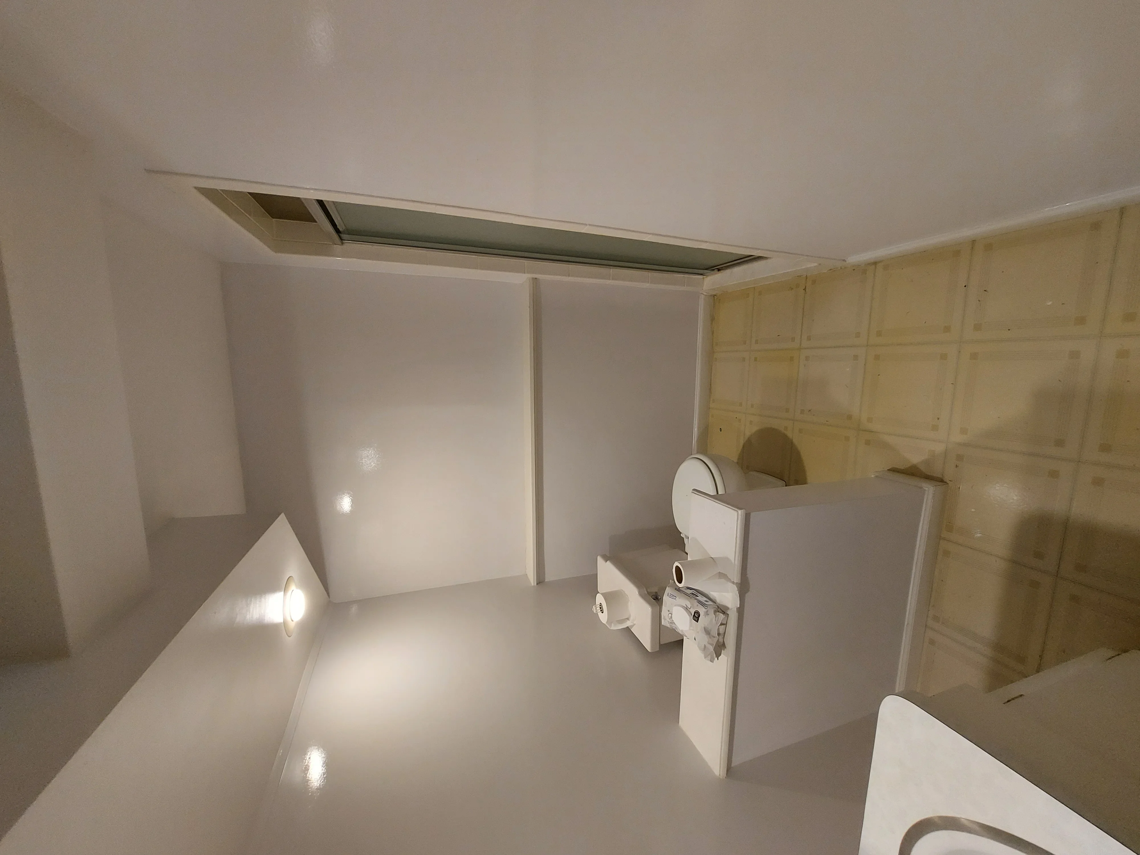 Commercial kitchen with white drywall, recessed lighting, epoxy flooring, and cabinetry framing