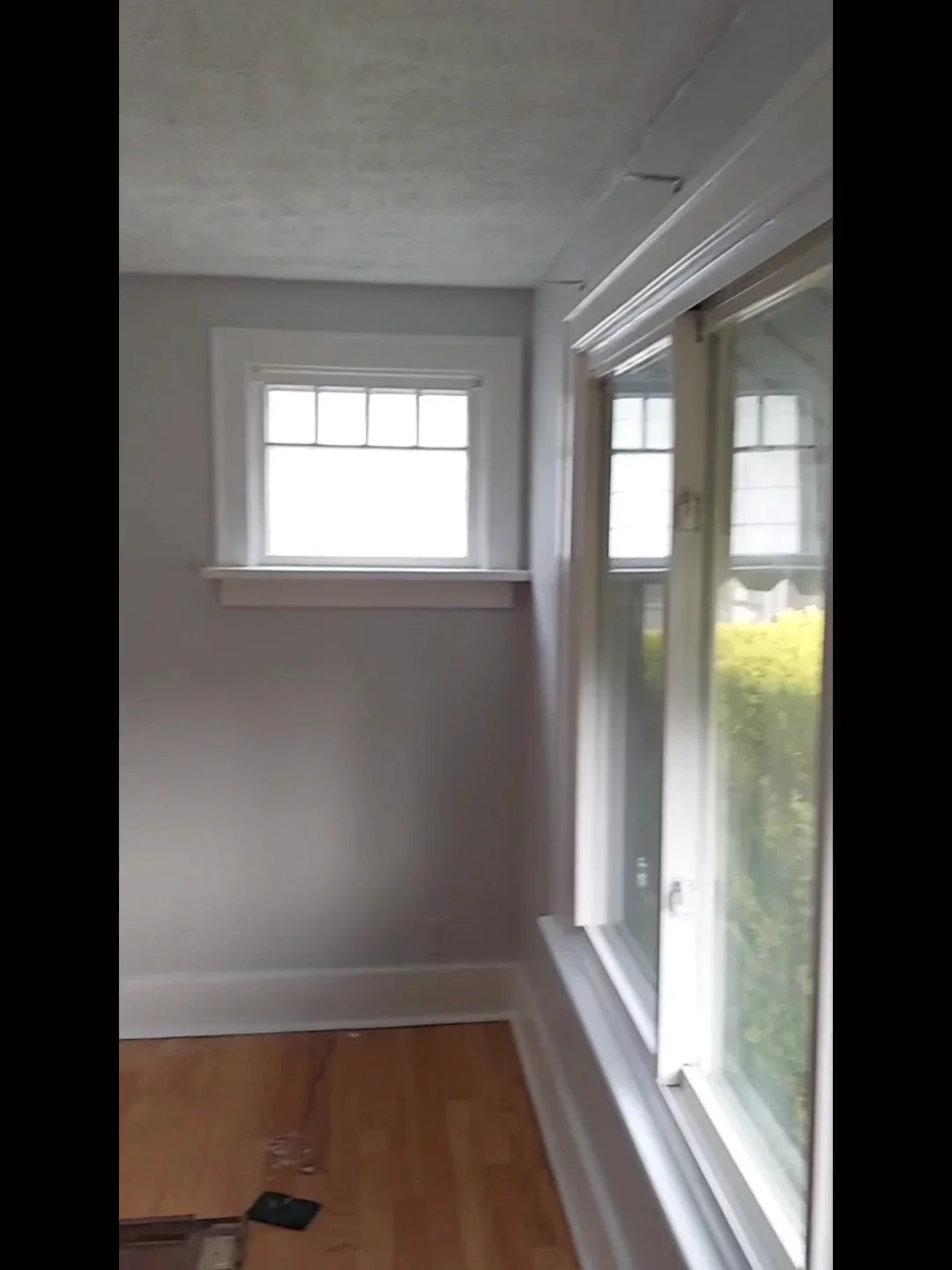 Finished drywall, white trim, recessed lighting, and glass door with LED strips in renovated interior space