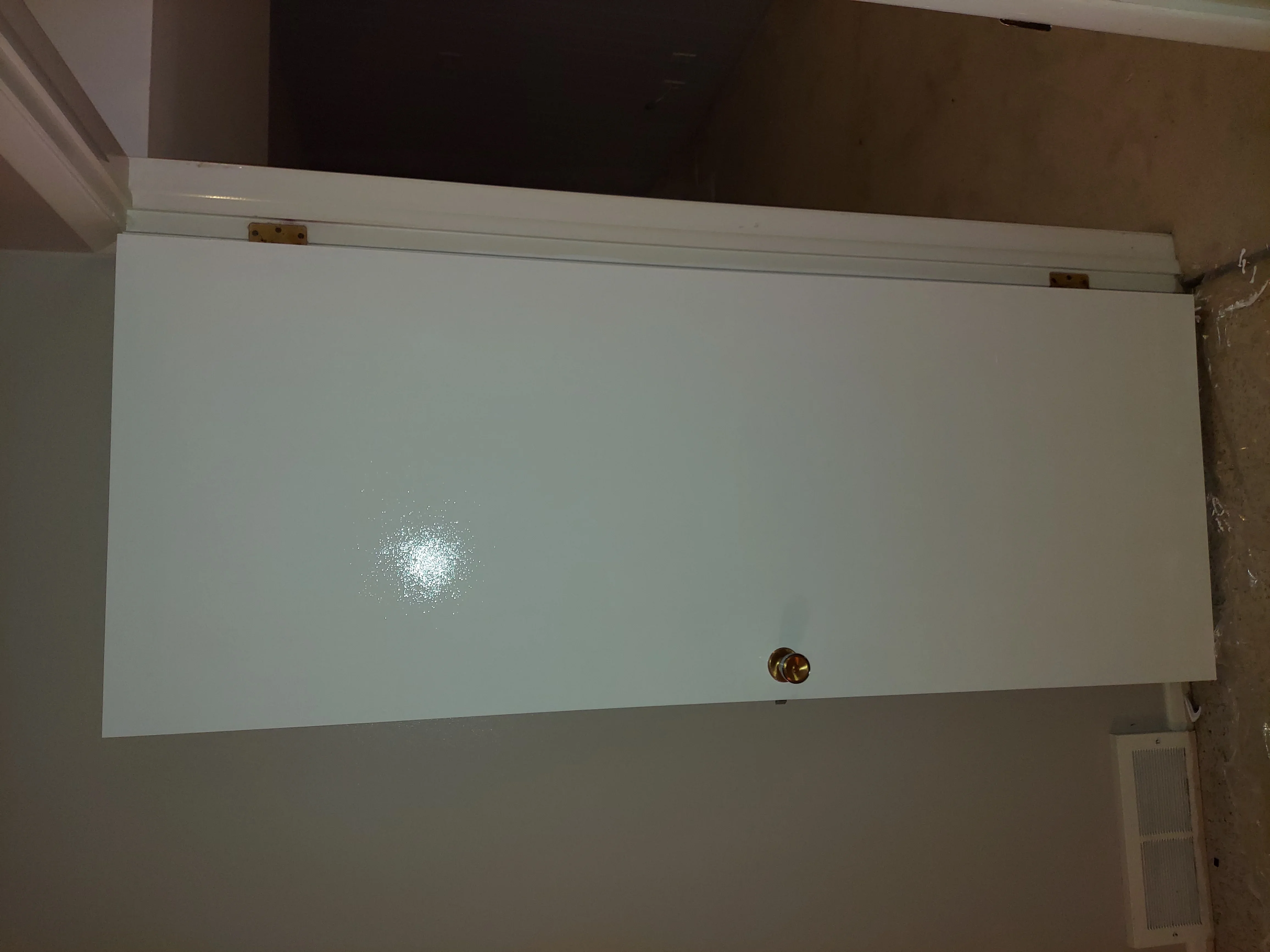 White vinyl soffit panel with brass hardware and trim installation