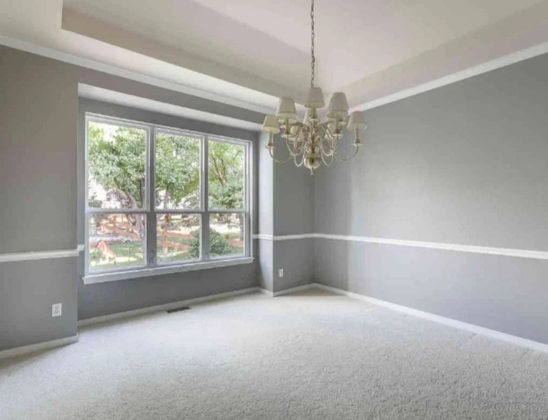 Two-tone painted bedroom with white chair rail, new carpet, and multi-pane window installation